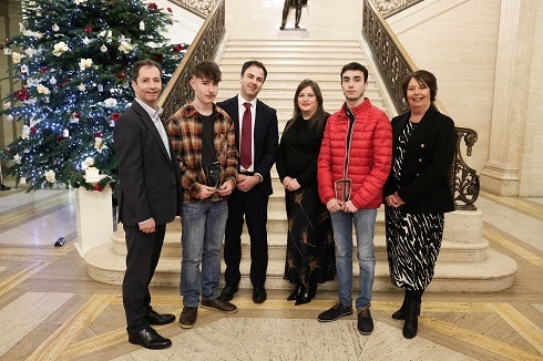 Group standing at bottom of stairs in stormont building