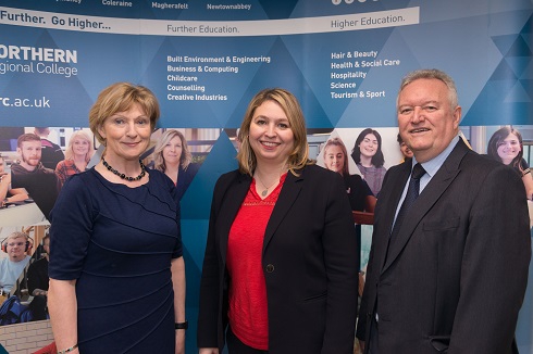 Principal pictured with male and female secretary of state in front of College pull up stand