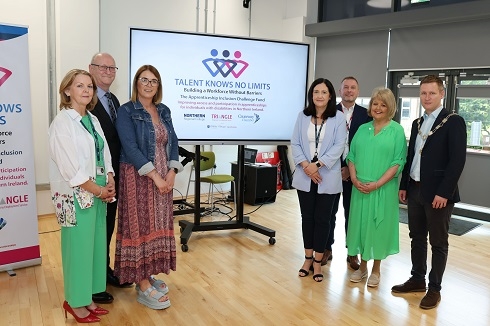 Group of people standing at screen