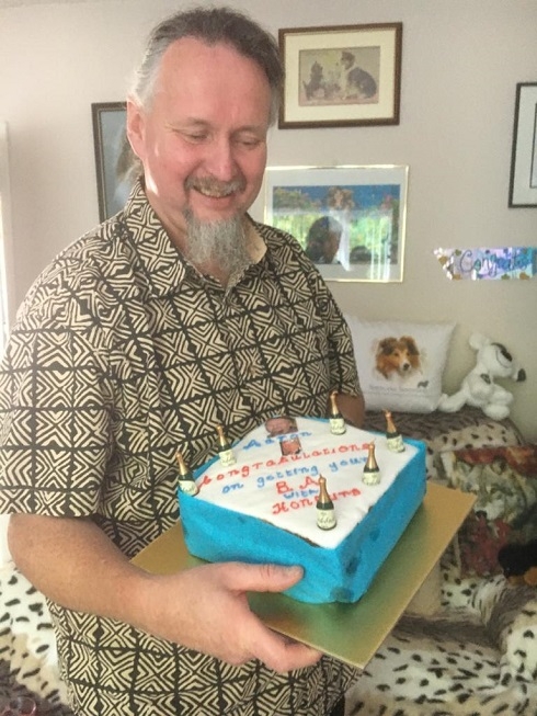 Former Art Student Holding A Cake