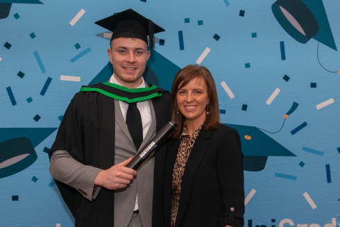 Male graduand standing with female