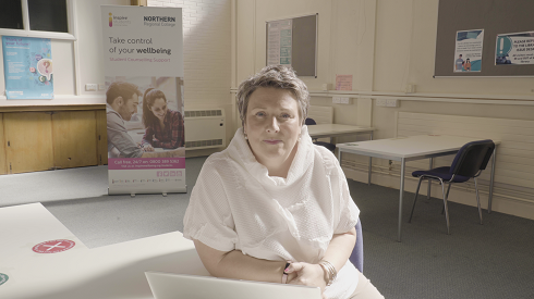 Female sitting in a library
