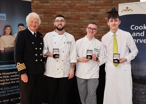 Catering students with their medals alongside representative from Royal Navy