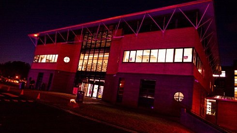 Newtownabbey Campus lit up with purple light