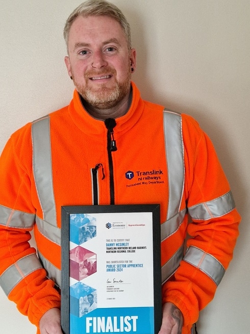 Male holding a certificate