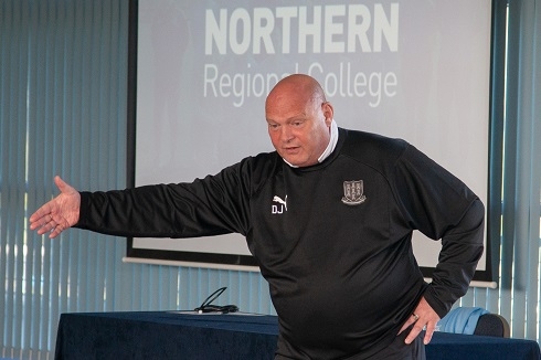 Male football manager presenting