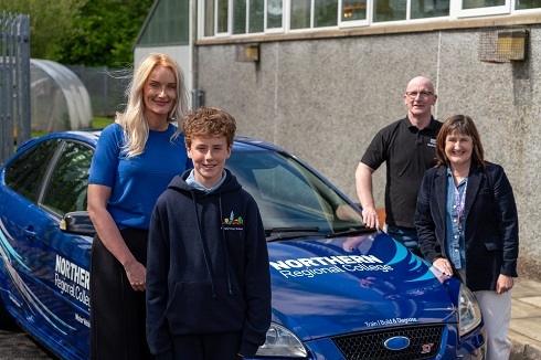 Group standing at branded car