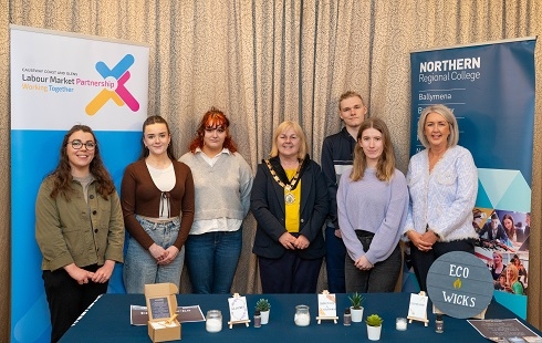 Group standing with deputy mayor in front of pullup stands