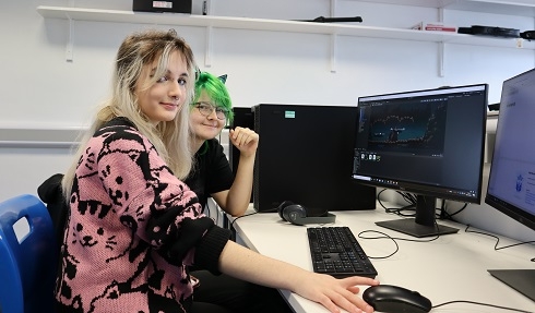 Two females sitting at computer