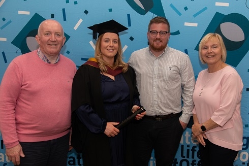 Female graduand pictured with her family