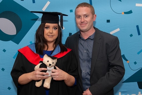 Female graduand with fiance at graduation