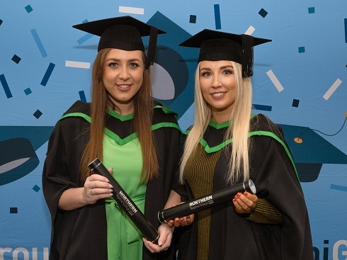 Two females in graduation gowns