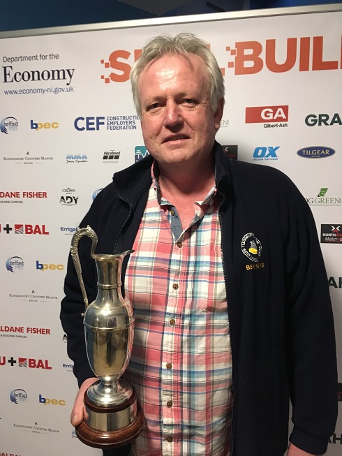 Male lecturer pictured with his award