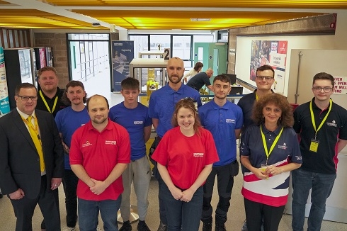 Group of people standing in foyer at industrial robotics competition