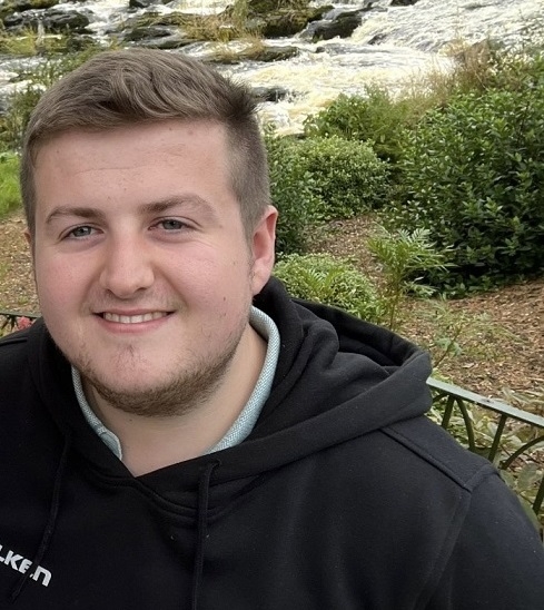 Male standing at a river