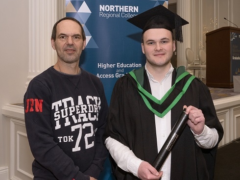 Father pictured with his son at graduation