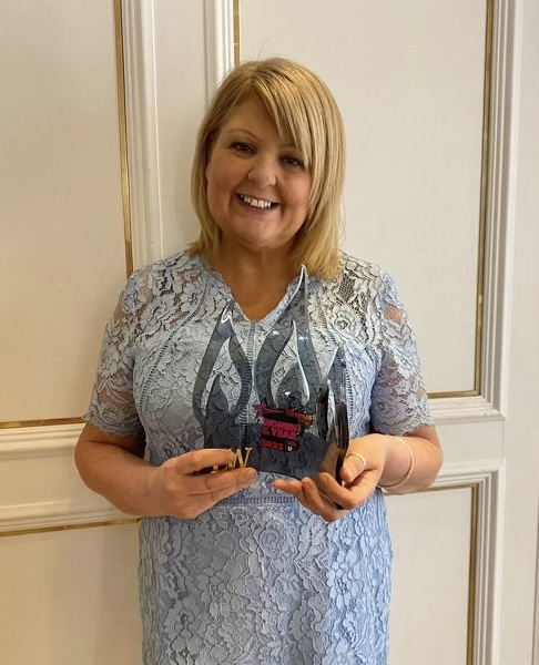 Female holding an award
