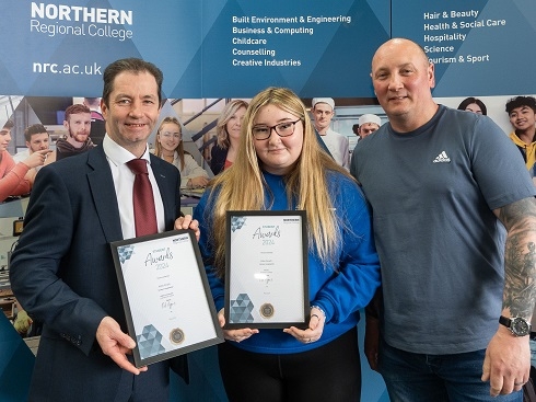 Female student with parent being awarded certificates from Principal