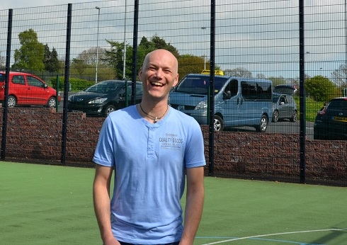 Male standing in football pitch