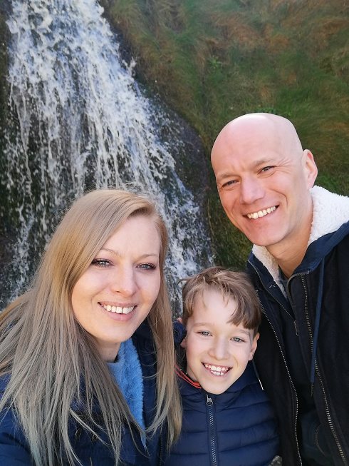 Group family photo at a waterfall