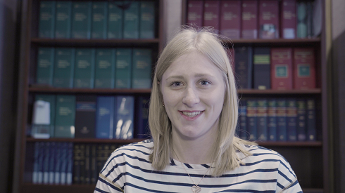 Female sitting in front of bookcase