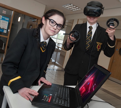 School pupil with VR headset alongside female pupil