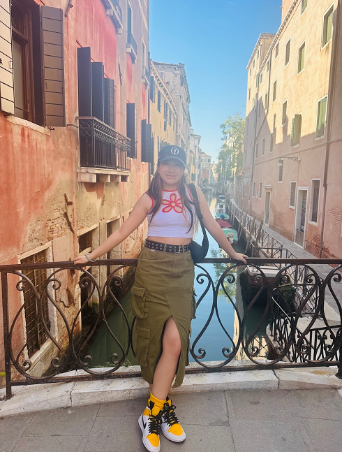 female standing on a bridge
