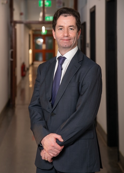 Male standing in corridor