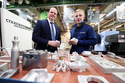 Minister with male student within workshop