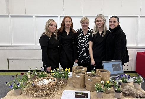 Group of females standing at a table