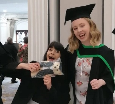Mum and daughter pictured at graduation holding graduation teddy