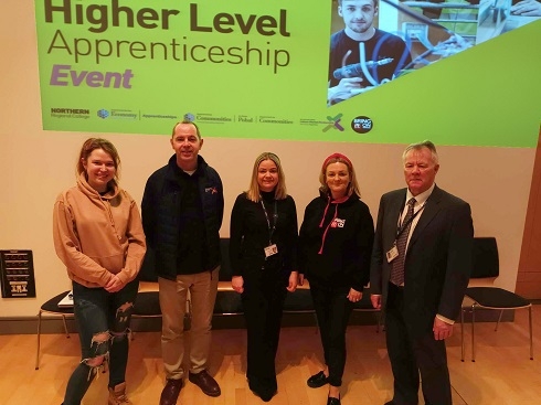 Group of people standing in front of a screen