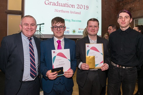 Group of male students with their certificate