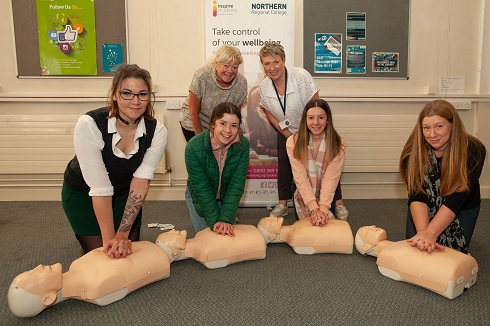 Staff doing CPR training on dummies