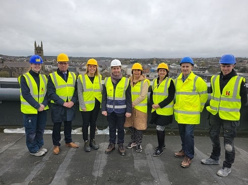 Group wearing high vis vests and hard hats on construction site
