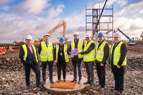 Group wearing hard hats and high vis vests on a constuction site