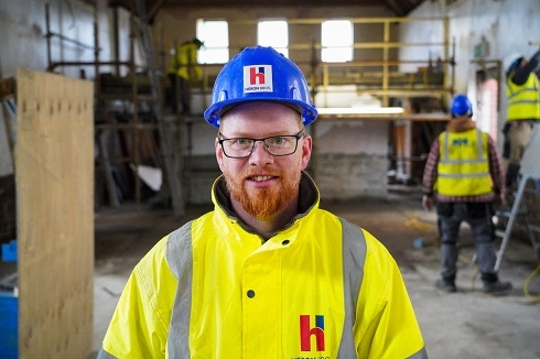Male in yellow high vis jacket and hard hat