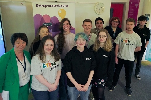 Group of people standing in front of entrepreneurship club pull up stand