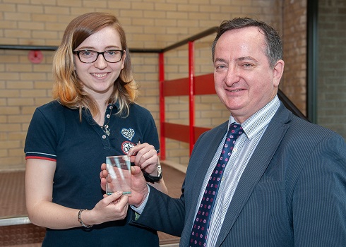 Female student being presented an award by Vice-Principal