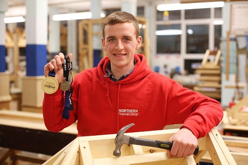 Male student with gold medal