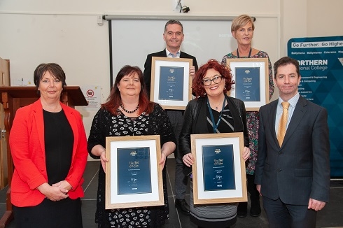Staff holding their certificates