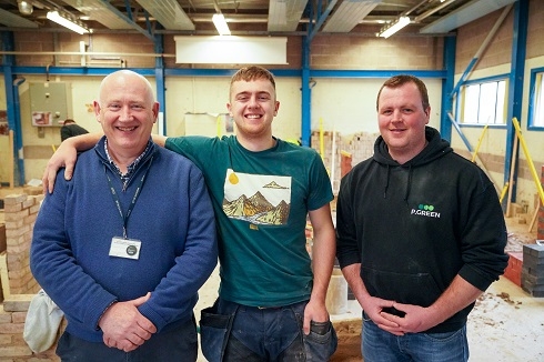 Three males in joinery workshop