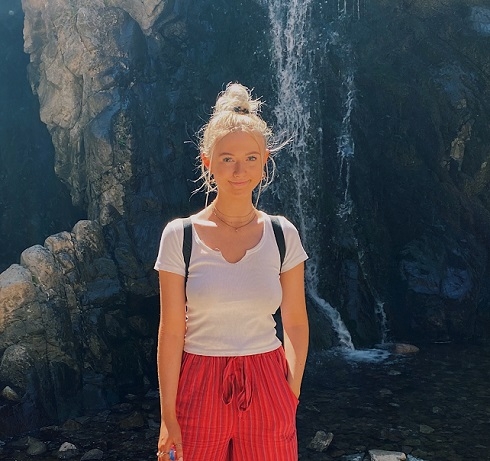 Female standing in front of a waterfall