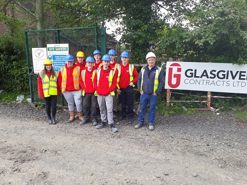 Group of students with hard hats and high vis vests