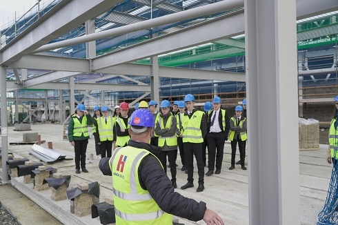 Group wearing high vis vests and hard hats on a construction site