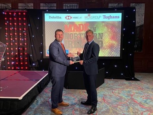Two males holding an award