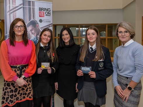 Group of females with award winners holding their vouchers