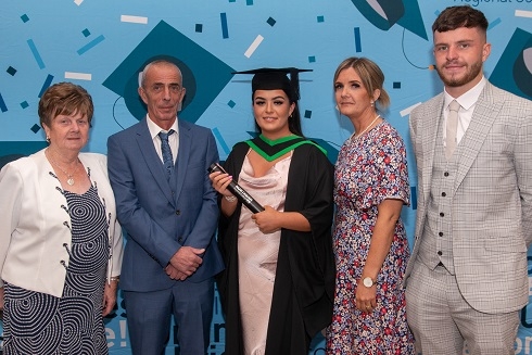 Female graduand pictured with her family
