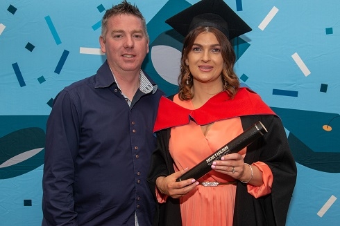 Female graduand pictured with her male partner