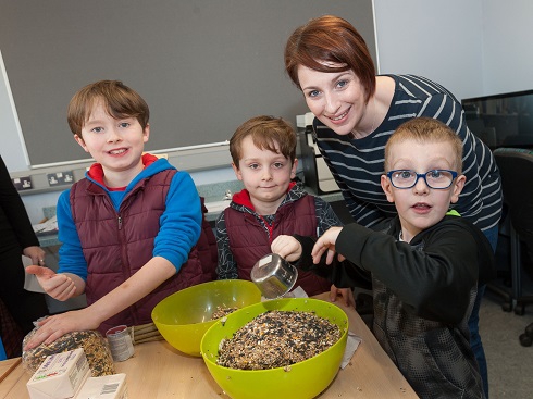 Group of children with adult taking part in crafts